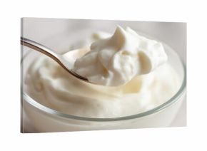 Creamy textured greek yogurt in glass bowl with spoon