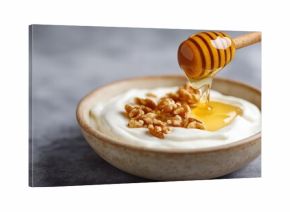Greek yogurt bowl with honey and walnuts on gray background healthy breakfast food with natural sweetener and nutritious topping for diet