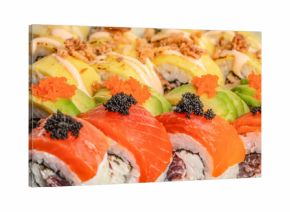 Luxury sushi rolls with salmon, avocado and red and black caviar topping in close up view