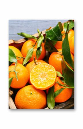 Tray with sweet mandarins and leaves on blue wooden background