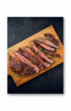 Barbecue grilled dry aged meat wagyu beef flank steak cut as tagliata on wooden board with text space