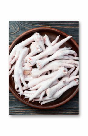 Raw chicken foot ( paws ) Top view on rustic background