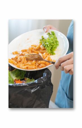 Compost from leftover food asian young housekeeper woman, girl hand holding macaroni plate use fork throw away food scraps, rotten vegetable into trash. Environmentally responsible, food waste concept