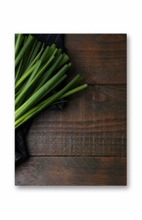 Bunch of fresh green onions on wooden table, top view. Space for text