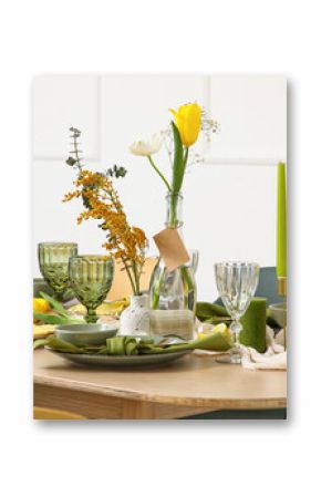Table setting with spring flowers in light room