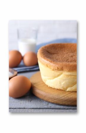 Tasty Japanese Castella sponge cake and ingredients on grey wooden table, closeup