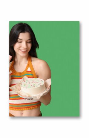 Beautiful young woman with sweet bento cake and gift box on green background. International Women's Day