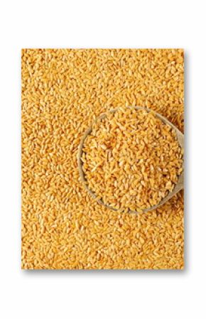 Organic golden flax seeds, linseed grains in wooden spoon background and texture
