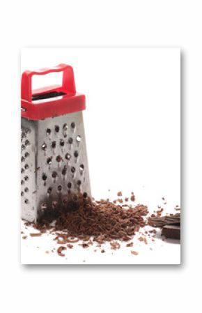 Kitchen grater and pile chopped, dark chocolate isolated on white background