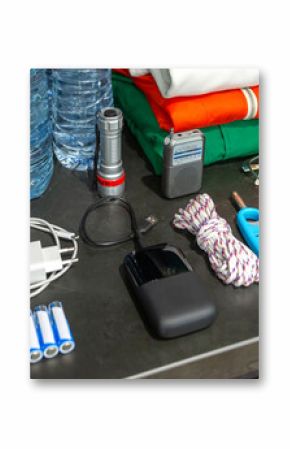 Banner of 72 hour survival kit in kitchen cupboard with water bottles, clothes, radio, batteries, powerbank, flashlight, knife and lighter. Full pantry ready for disasters, war, pandemic or blackout.