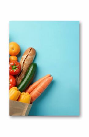 Grocery paper bag full fresh fruits vegetables on blue background. Variety of organic food. Healthy eating diet concept. Delivery service shopping concept. Flat lay, top view, copy space. Fresh food
