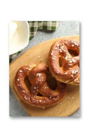 Tasty pretzels with salt and butter on light grey table, flat lay