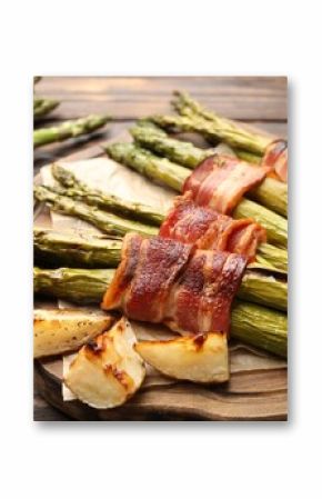 Tasty cooked asparagus, bacon and potatoes on wooden table, closeup