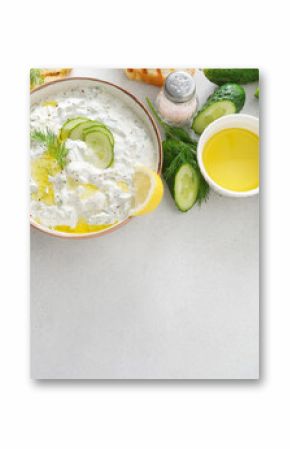 Tzatziki salad with roasted bread in white bowl on white background. Homemade Tzatziki salad with olive oil and copy space. Top view.