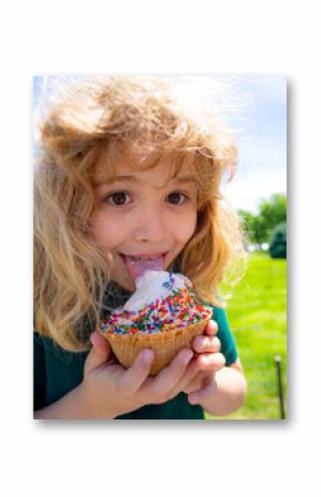Summer kids face. Child eating ice cream. Summer sweets. Kid licking ice cream cone in summer park. Little funny boy face with ice-cream close-up. Summer child funny portrait. Kids fun face.