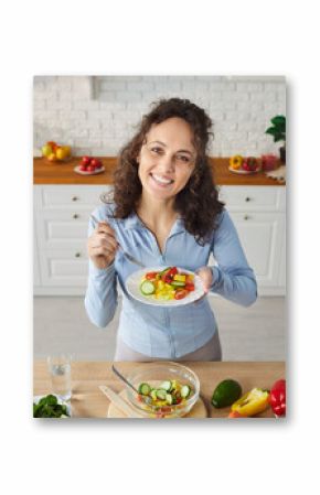 Portrait of a woman eating vegetable salad on kitchen at home, highlighting healthy food and wellness, serene moment in a personal space dedicated to nutritious meals and culinary enjoyment.