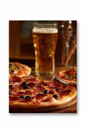The delicious pizza and refreshing beer served on a rustic wooden table