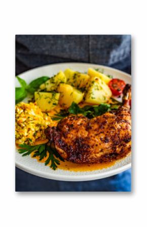 Woman holding plate with oven roasted chicken leg with boiled potatoes and young cabbage salad, close-up