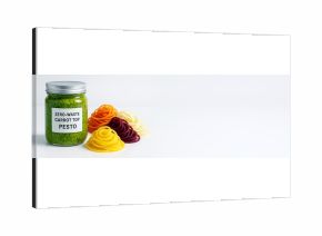 Jar of zero-waste carrot top pesto with colorful vegetable noodles on clean white background with copy space for food promotion or design mockup. Ai generative