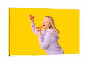 Young happy woman holding pieces of tasty pizza on yellow background