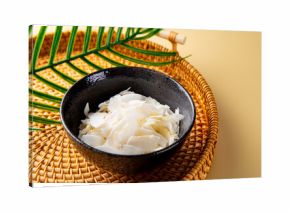 Coconut chips in a bowl. Cocos nucifera.