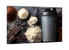 A protein shaker bottle surrounded by various protein powders and almonds on a marble surface
