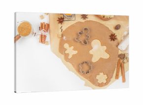 Gingerbread cookie dough with cutters, spices, and ingredients on kitchen table, top view, free space for text