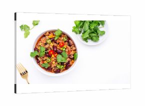 Spicy beef chili con carne with red beans, sweet corn, fresh cilantro, jalapeno pepper and tomato, served on white table, top view