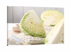 Fresh cut Savoy cabbage and knife on table, closeup