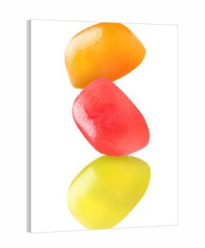 Sweet jelly candies falling against white background
