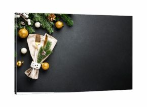 Modern golden cutlery and christmas decorations at black.