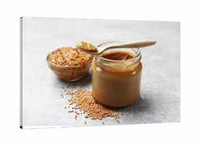 Different types of mustard on light grey table, closeup