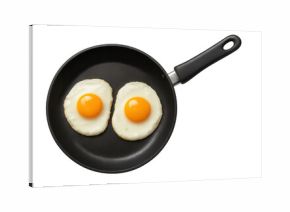 Fried eggs cooking in black frying pan, preparing breakfast food, top view with transparent background