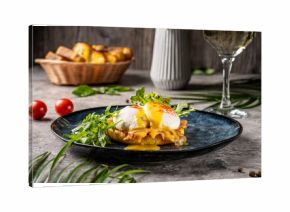 Eggs Benedict with hollandaise and arugula