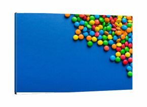 Mixed collection of colorful candy, on colored background. Flat lay, top view. frame of colorful chocolate coated candy
