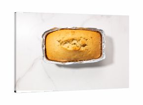 pound cake food in foil baking dish top view concrete surface