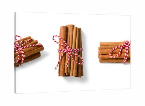 Three bundles of cinnamon sticks tied with red and white twine isolated on a transparent background, PNG. High resolution. Natural Aromatic Spice for Cooking and Baking