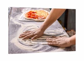 Hands preparing a pizza or making a homemade pepperoni pizza. Cook hand makes a pizza, puts the sausage on top. Hand sprinkling cheese on pizza dough with tomato sauce