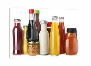 Bottles and jars with different tasty sauces isolated on white