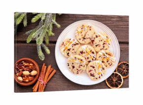 Christmas holiday cranberry orange icebox cookies. Top down view table scene on a dark wood background.