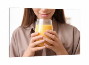 Young woman holding glass of tasty turmeric drink on white background, closeup