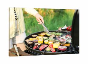 Vegetarian barbeque. Woman cooking vegetables on grill outdoors, closeup