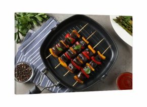 Skewers with tasty grilled vegetables served on grey table, flat lay