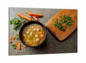 Classic meatball soup with potatoes,  carrot and greens.