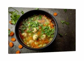 Classic meatball soup with potatoes,  carrot and greens.