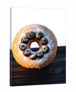 Blueberry Donut with Powdered Sugar and Dramatic Backlighting