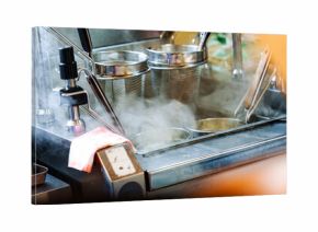 Hot steaming ramen noodle cooking with stainless kitchen equipment