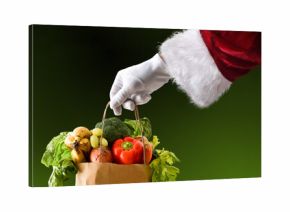 Santa's hand holding a bag full of food isolated background