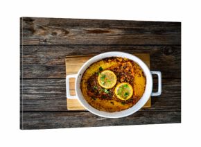 Baked salmon fillet on wooden table. Top view