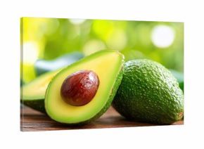 The Avocado Halves on Wooden Surface with Bright Bokeh Background